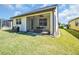 Backyard with a screened-in porch and a well-maintained lawn on a sunny day at 7234 Sw 91St Ct, Ocala, FL 34481