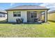 Lush backyard with well-kept lawn, screened patio and covered barbecue area, for ultimate outdoor enjoyment at 7234 Sw 91St Ct, Ocala, FL 34481