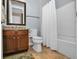 Bathroom features a bathtub with shower and a wooden vanity with granite countertop at 7234 Sw 91St Ct, Ocala, FL 34481