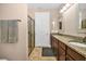 Bathroom boasts double vanity with granite countertop and a glass-enclosed shower at 7234 Sw 91St Ct, Ocala, FL 34481