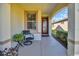 Covered porch featuring a seating area and a view of the surrounding neighborhood at 7234 Sw 91St Ct, Ocala, FL 34481