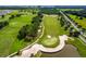 Aerial photograph of golf course showcasing sand traps, trees, and neatly trimmed greens at 7234 Sw 91St Ct, Ocala, FL 34481
