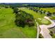 Overhead view of a verdant golf course featuring a sand trap and a manicured green at 7234 Sw 91St Ct, Ocala, FL 34481