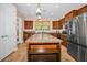 Modern kitchen island with a granite countertop and stainless steel appliances at 7234 Sw 91St Ct, Ocala, FL 34481