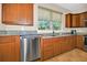 Updated kitchen includes granite countertops, stainless steel dishwasher, and ample cabinet space at 7234 Sw 91St Ct, Ocala, FL 34481