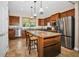 Spacious kitchen boasts granite countertops, stainless steel appliances, and a large island with breakfast bar seating at 7234 Sw 91St Ct, Ocala, FL 34481