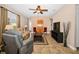 Inviting living room featuring tile floors, a ceiling fan and large furniture at 7234 Sw 91St Ct, Ocala, FL 34481