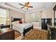 The main bedroom is spacious with a tray ceiling, ceiling fan and tile flooring at 7234 Sw 91St Ct, Ocala, FL 34481