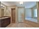 Bathroom showcasing double sink vanity, linen closet, and a tile surround walk-in shower and soaking tub at 78 Pecan Run, Ocala, FL 34472