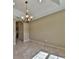 Empty dining room featuring chandelier lighting and tile flooring at 78 Pecan Run, Ocala, FL 34472