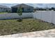Large backyard with a newly planted tree, enclosed by a white vinyl fence for privacy at 7935 Sw 89Th Ter, Ocala, FL 34481