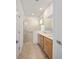 Well-lit bathroom featuring a double vanity, and a walk-in shower with glass door at 7935 Sw 89Th Ter, Ocala, FL 34481
