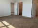 Bright bedroom with carpet floors leading to an open closet and views of other rooms at 7935 Sw 89Th Ter, Ocala, FL 34481