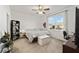 Bright bedroom features a ceiling fan, large window, and cozy decor at 7935 Sw 89Th Ter, Ocala, FL 34481