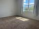 Bright carpeted bedroom with a sunny window and neutral decor at 7935 Sw 89Th Ter, Ocala, FL 34481