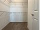 Walk-in closet features wire shelving and carpeted floor for storage at 7935 Sw 89Th Ter, Ocala, FL 34481