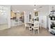 Open-concept dining area connected to a kitchen with stainless steel appliances and light wood cabinetry at 7935 Sw 89Th Ter, Ocala, FL 34481