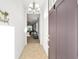 Inviting entryway showcasing tiled floors and a modern chandelier leading into a naturally lit living space at 7935 Sw 89Th Ter, Ocala, FL 34481