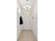 Bright entryway features neutral tile flooring, white trim and walls, and a modern light fixture at 7935 Sw 89Th Ter, Ocala, FL 34481