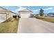 Charming single-Gathering home featuring a two-car garage and well-manicured lawn and landscaping at 7935 Sw 89Th Ter, Ocala, FL 34481