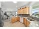 Open kitchen with granite countertops, stainless steel appliances, and views to the dining and living areas at 7935 Sw 89Th Ter, Ocala, FL 34481