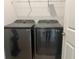 Modern black washer and dryer set in a dedicated laundry area with shelving at 7935 Sw 89Th Ter, Ocala, FL 34481