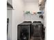 Laundry room is equipped with modern black front load washer and dryer at 7935 Sw 89Th Ter, Ocala, FL 34481