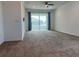 Inviting living room with a ceiling fan, neutral carpet, and sliding glass doors at 7935 Sw 89Th Ter, Ocala, FL 34481