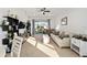 Bright living room with neutral tones, ceiling fan, and sliding glass doors to the lanai at 7935 Sw 89Th Ter, Ocala, FL 34481