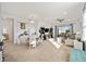 Open-concept living area with neutral carpeting, modern furnishings, and abundant natural light at 7935 Sw 89Th Ter, Ocala, FL 34481