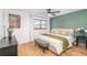 Light-filled bedroom featuring wooden floors and serene green accent wall at 8665 Sw 94Th Ln # C, Ocala, FL 34481