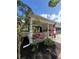 Inviting front yard showcasing lush landscaping and a covered porch adorned with vibrant flowers and an American flag at 8665 Sw 94Th Ln # C, Ocala, FL 34481