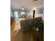 Bright living room with hardwood floors, ceiling fan, and neutral color palette at 8665 Sw 94Th Ln # C, Ocala, FL 34481
