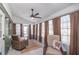 Bright sunroom with large windows, neutral tile, and seating, perfect for relaxation and enjoying the view at 8665 Sw 94Th Ln # C, Ocala, FL 34481