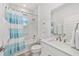 Well lit bathroom with a shower/tub combination, quartz countertop and a framed mirror at 8769 Sw 79Th Pl, Ocala, FL 34481