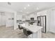 Modern kitchen featuring stainless steel appliances, white cabinetry, and a large center island at 8769 Sw 79Th Pl, Ocala, FL 34481