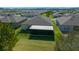 Aerial shot of a backyard with screened in patio, fence, and the surrounding neighborhood at 8825 Sw 57Th Place Rd, Ocala, FL 34481