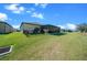 Expansive backyard features a screened lanai and lush green grass, perfect for outdoor living at 8825 Sw 57Th Place Rd, Ocala, FL 34481