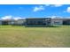 Expansive backyard featuring a screened lanai, ideal for relaxation and outdoor activities at 8825 Sw 57Th Place Rd, Ocala, FL 34481