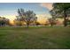 Scenic golf course view showcasing lush green fairways and mature trees against a vibrant sky at 8825 Sw 57Th Place Rd, Ocala, FL 34481