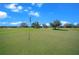 Picturesque view of the golf course with well-maintained greens and a blue sky backdrop at 8825 Sw 57Th Place Rd, Ocala, FL 34481