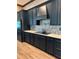 A close-up of a modern kitchen featuring stainless steel appliances, sleek cabinetry, and a stylish backsplash at 8825 Sw 57Th Place Rd, Ocala, FL 34481
