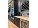 The kitchen showcases stainless steel appliances, a wine rack, and under-cabinet lighting, blending style and functionality at 8825 Sw 57Th Place Rd, Ocala, FL 34481