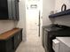 Well-lit laundry room with modern washer and dryer, custom cabinets and tile floors at 8825 Sw 57Th Place Rd, Ocala, FL 34481