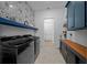 Well-organized laundry room with modern black appliances and plenty of storage at 8825 Sw 57Th Place Rd, Ocala, FL 34481