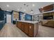 An open-concept layout showcases a modern kitchen with a large island, seamlessly connected to the living areas at 8825 Sw 57Th Place Rd, Ocala, FL 34481