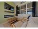 Cozy outdoor patio featuring a mounted TV, fireplace, comfortable seating, and a wood coffee table at 8825 Sw 57Th Place Rd, Ocala, FL 34481