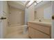 Neutral bathroom featuring a shower and tub combination, tile walls, and modern lighting at 8832 Sw 108Th St, Ocala, FL 34481