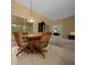 Casual dining area featuring a round table, wooden chairs, and access to the lanai at 8832 Sw 108Th St, Ocala, FL 34481