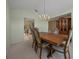 Formal dining room featuring a chandelier and a large wood table with seating for six at 8832 Sw 108Th St, Ocala, FL 34481